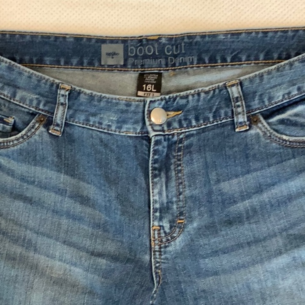 Mid rinse, boot cut jeans with light distressing